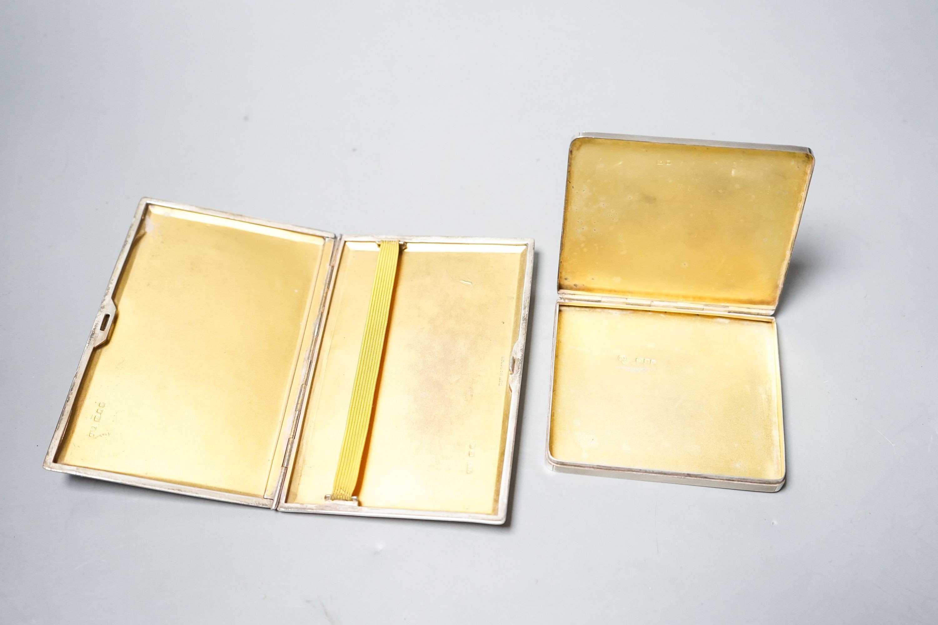 A George VI silver and yellow metal banded square cigarette case, London, 1950, 92mm and one other cigarette case, gross 3.4 grams.